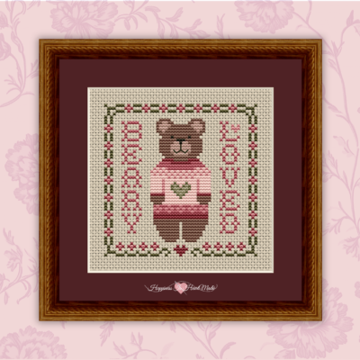 Beary Loved cross stitch pattern from Happiness Is HeartMade - Pattern 7700 - A cute teddy bear with a pink sweater - adorable for Valentine's Day - a play on the words Very Loved