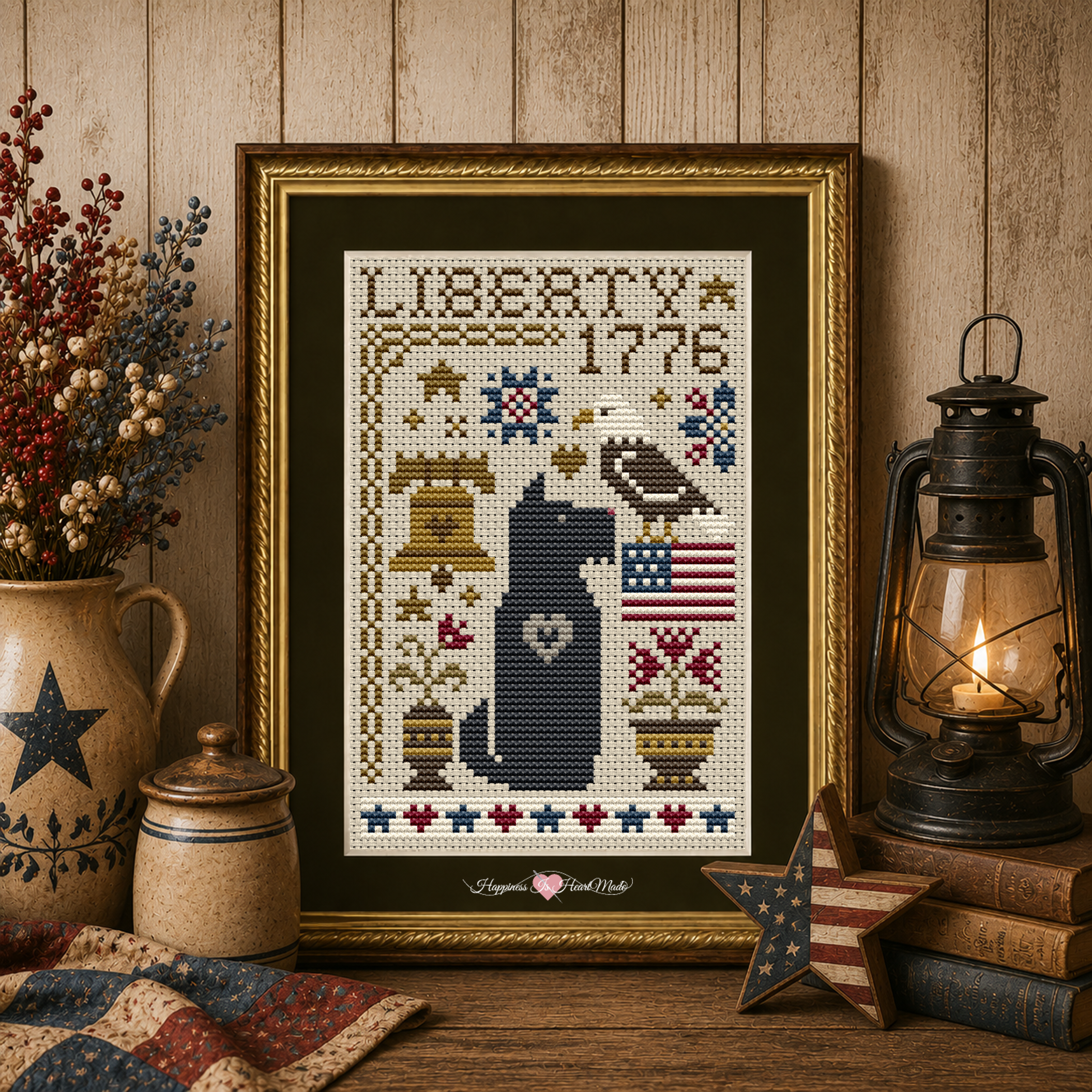 Scottie Liberty Dog Cross Stitch Pattern 6587-S from the Dog Days Series by Happiness Is HeartMade. This patriotic counted cross stitch pattern was design by Christy Shuhy Ortiz. A Black Scottish Terrier is the central motif in this design, and the words "Liberty 1776" are stitch along the top. The design also includes Americana-themed motifs of a bald eagle, American flag, Liberty Bell, flowers, hearts, and stars.